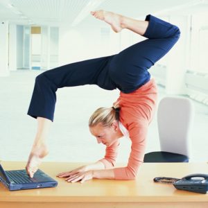 CONTORTIONIST USING LAPTOP COMPUTER WITH FEET